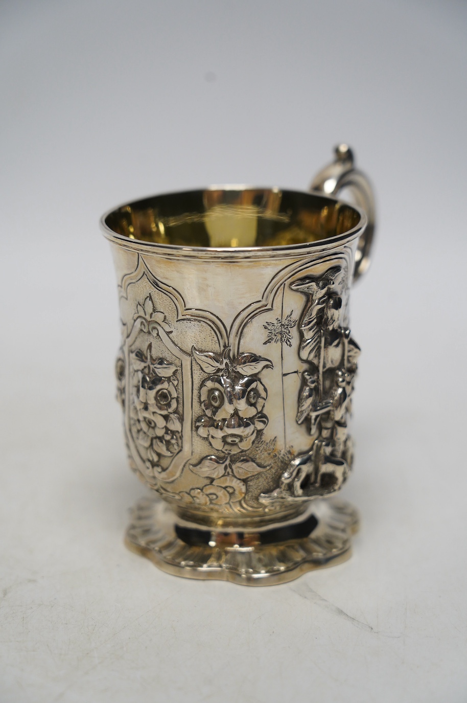 A Victorian silver christening mug, embossed with a gentleman with birds and dogs, James Charles Edington, London, 1853, 10.5cm, 6.6oz. Condition - fair to good